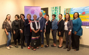 Grant recipients stand with Minister Kelly Regan, Minister Responsible for the Nova Scotia Advisory Council on the Status of Women (4th from left), Elder Marleen Companion (5th from left), and MP Andy Filmore (6th from left).